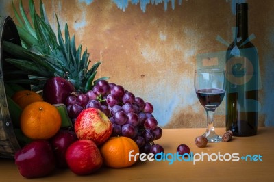 Fruits And Wine Bottles On Wooden Stock Photo