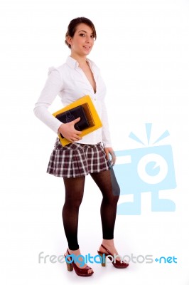 Full Body Pose Of Smiling Young Student With Books Stock Photo