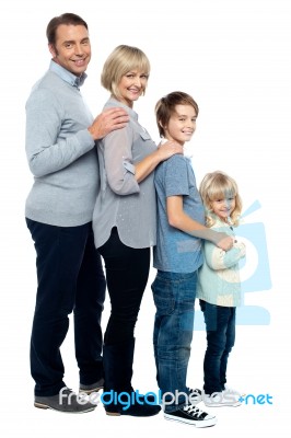 Full Length Family Portrait Of Four Members Stock Photo