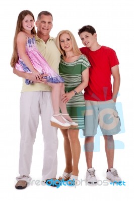 Full Length Of Happy Family Looking At You Stock Photo