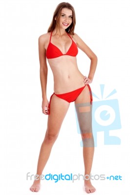 Full Length Of Stunning Woman In Red Bikini Posing Stock Photo