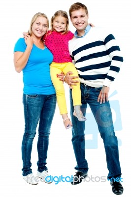 Full Length Portrait Of A Cheerful Family Of Three Stock Photo