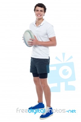 Full Length Portrait Of A Rugby Player Holding Ball Stock Photo