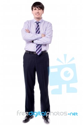 Full Length Shot Of Businessman With Folded Arms Stock Photo