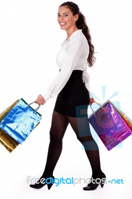 Full Length Shot Of Young Woman Holding Shopping Bag Stock Photo