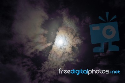 Full Moon Shining Glowing Light Through The Darkness Of Cloudy N… Stock Photo