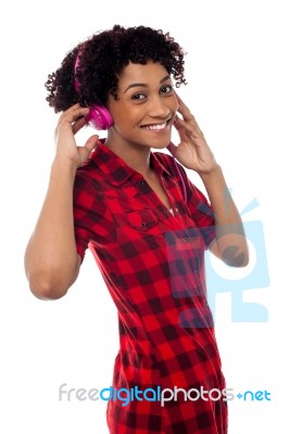 Fun Loving Girl Enjoying Lively Music Stock Photo