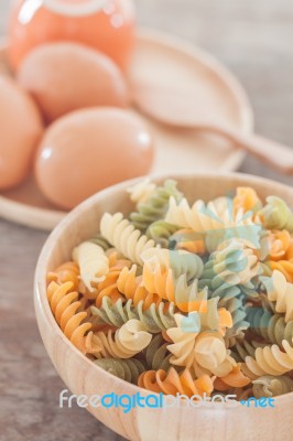 Fusili Pasta In Wooden Plate With Eggs Stock Photo