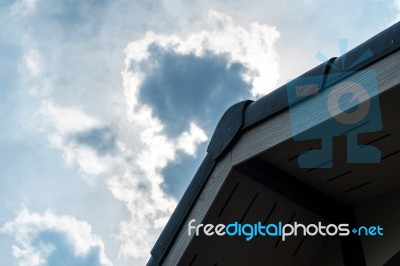 Gabled Roof Under A Cloudy Sky Stock Photo