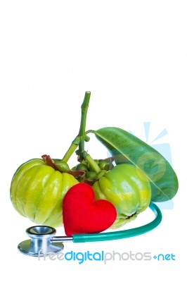 Garcinia Cambogia, Red Heart-shaped And Stethoscope On White Background Stock Photo