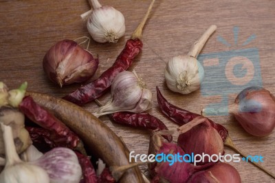 Garlic And Chillies On Wooden Stock Photo