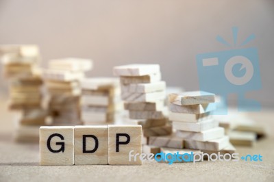 Gdp Word Written In Wooden Cube On Wood Table With Wooden Stack Stock Photo