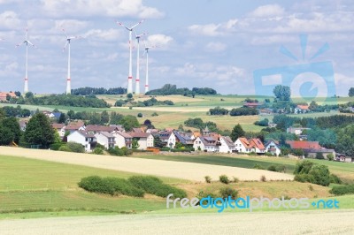 German Village With Houses, Windmills And Corn Fields Stock Photo