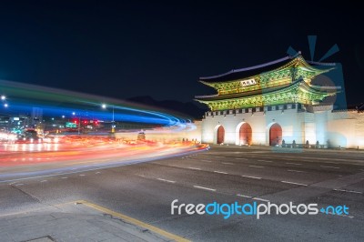 Geyongbokgung Palace And Car Light At Night In Seoul, South Korea Stock Photo