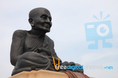 Giant Black Monk Statue In Thailand Temple Stock Photo