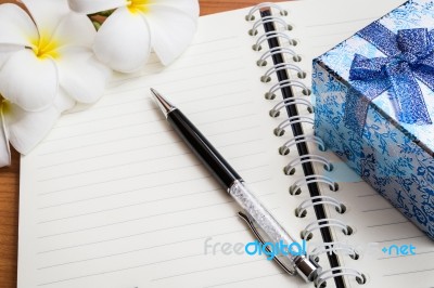 Gift Box And Pen On Notebook Stock Photo