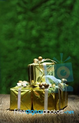 Gift Box On Old Wooden With Green Bokeh Background Stock Photo