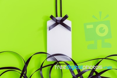 Gift Tag With Ribbon On Green Stock Photo