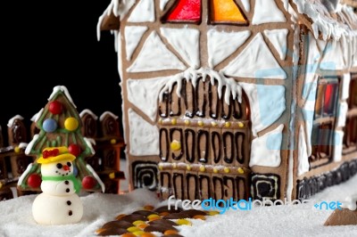 Gingerbread House And A Snowman Stock Photo