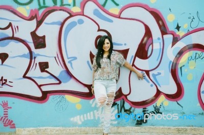 Girl Against Graffiti Wall Stock Photo