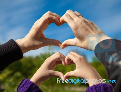 Girl And Her Mother Show Sign Of Heart With Their Hands Stock Photo