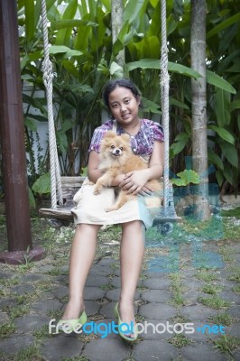 Girl And Pomernian Dog Stock Photo