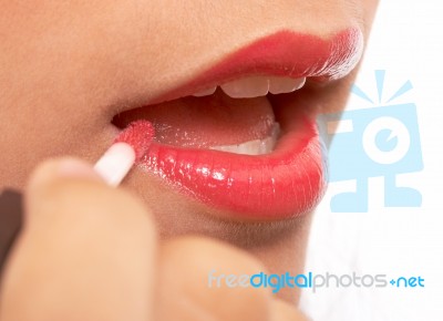 Girl Applying Lip Gloss Stock Photo