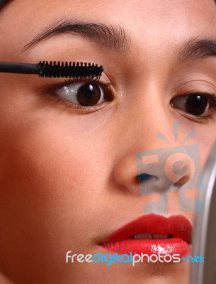 Girl Applying Mascara Stock Photo