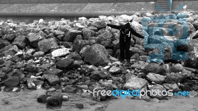 Girl Balancing On Large Rocks Stock Photo