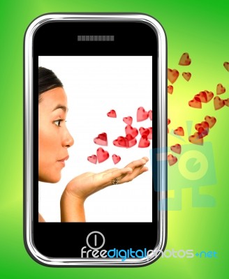 Girl Blowing Hearts From Mobile Stock Image