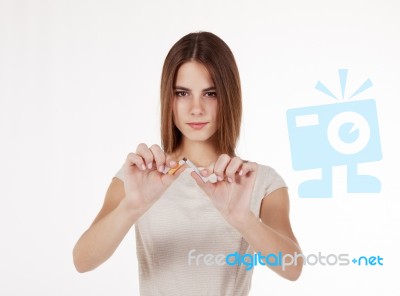 Girl Breaking A Cigarette Stock Photo