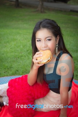 Girl Eating A Cheeseburger Stock Photo