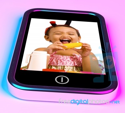 Girl Eating Corn On Mobile Phone Stock Image