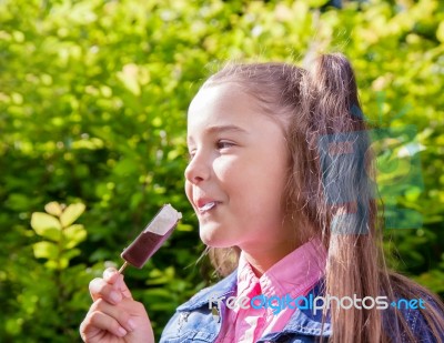 Girl Eating Ice Cream Outside Stock Photo