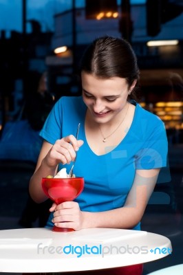 Girl Eating Tempting Dessert Stock Photo