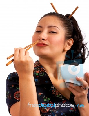 Girl Eating With Chop Sticks Stock Photo