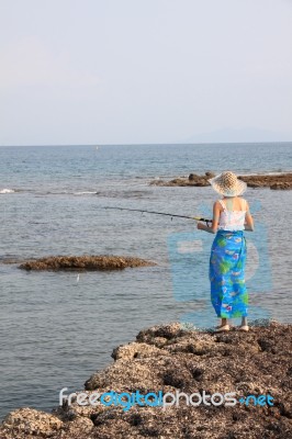 Girl Fishing On Beach Stock Photo