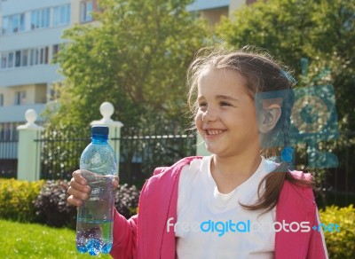 Girl Holding A Plastic Bottle With Water Stock Photo