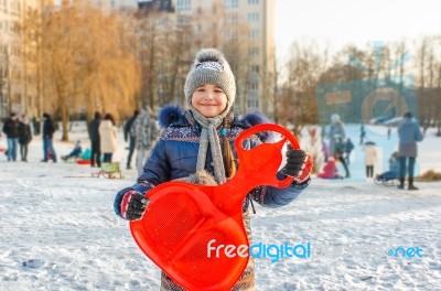 Girl Holding A Sled Stock Photo