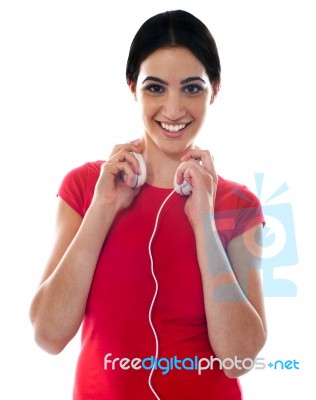 Girl Holding Headphone Stock Photo