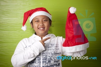 Girl Holding Santa Claus Hat Stock Photo