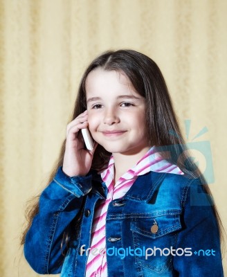 Girl In A Blue Denim Jacket Talking On A Phone Stock Photo