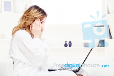 Girl In Bathrobe Chatting On Computer Stock Photo