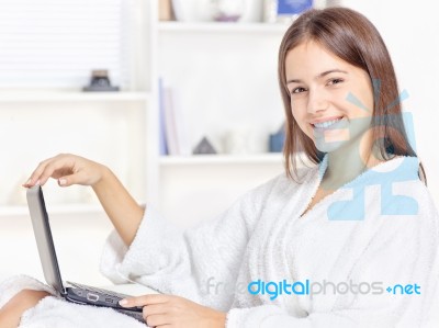 Girl In Bathrobe With Computer Stock Photo