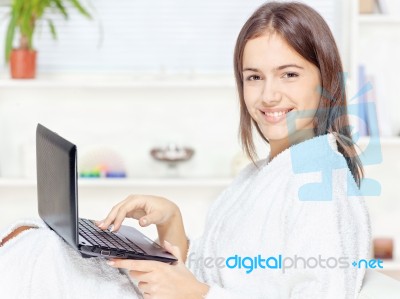 Girl In Bathrobe With Computer Stock Photo