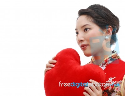 Girl in Chinese Dress Holding Heart Stock Photo