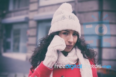 Girl In Red Coat And Wool Cap And Gloves With Smartphone In Hand… Stock Photo