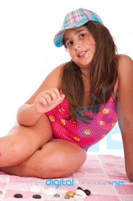 Girl In Swimsuit Playing With Stones Stock Photo