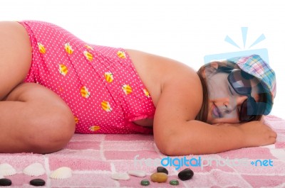 Girl In Swimsuit Sleeping At The Beach Stock Photo