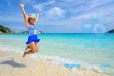 Girl Jumping With Happy On The Beach At Thailand Stock Photo